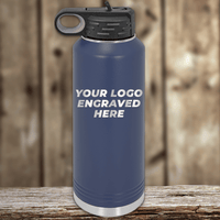 A blue metal water bottle by Kodiak Coolers with a black lid and your custom company logo engraved—ideal as a Realtor closing gift or paired with personalized mugs to promote your brand.