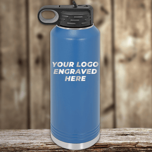 A blue insulated Kodiak Coolers water bottle with a black lid and your custom company logo engraved on the front—perfect as a realtor closing gift or to add to your promotional drinkware collection.