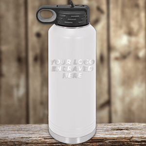A blank white Kodiak Coolers metal water bottle with a black lid on a wooden surface, featuring your custom company logo—ideal as a Realtor closing gift for clients and perfect promotional drinkware to showcase your brand.