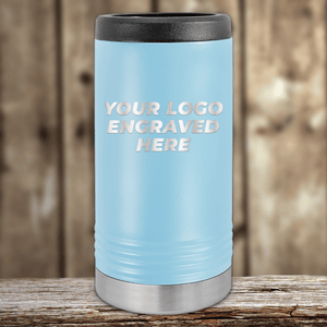 Light blue insulated tumbler with black lid and silver base by Kodiak Coolers, engraved with "YOUR LOGO ENGRAVED HERE"—ideal for Realtor closing gifts or custom company logo drinkware for clients.