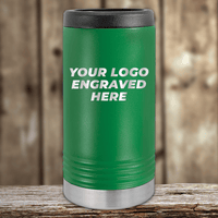 A green Kodiak Coolers stainless steel tumbler with a black lid and silver base, engraved with "YOUR LOGO ENGRAVED HERE," makes an ideal Realtor Closing Gift for clients—customize your company logo on Drinkware 2—shown on a wooden background.