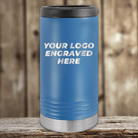 A blue Kodiak Coolers tumbler with a black lid and metallic base, engraved with your custom company logo, ideal as a Realtor Closing Gift for clients. Perfect for showcasing branded drinkware on a wooden surface.