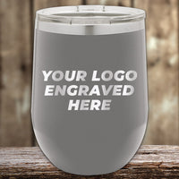 Kodiak Coolers' Custom Engraved Drinkware features your logo laser engraved on a gray insulated tumbler. Highlighted against a wooden backdrop, it's perfect for those wanting wholesale tumblers. Take advantage of the $250 minimal order during our Presidents Day Sale with no setup fee!.