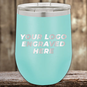 Aqua-colored Kodiak Coolers custom stemless wine cup with a customizable engraved logo area, displayed on a wooden surface.