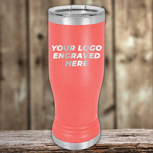 Customizable Kodiak Coolers Pilsner Tumblers 14 oz with your Logo or Design Engraved - Special Bulk Wholesale Pricing displayed on a wooden surface against a blurred background.