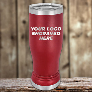 Custom Pilsner Tumblers 14 oz with your Logo or Design Engraved - Low 6 Piece Order Minimal Sample Volume by Kodiak Coolers displayed on a wooden surface with a blurred background.