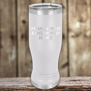 Kodiak Coolers Stainless steel Custom Pilsner Tumblers 14 oz with your Logo or Design Engraved displayed on a wooden surface with a blurred background.