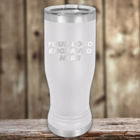 A Kodiak Coolers Custom Pilsner Glass 14 oz, laser-engraved with your logo or design, is displayed on wood—showcasing our special Black Friday sale with limited-time volume pricing.