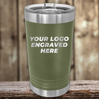 A Kodiak Coolers green insulated tumbler with silver accents is displayed on a wooden surface. The text reads, "Your Laser Engraved Logo Here," highlighting the Custom Engraved Drinkware. No setup fee, one side logo included for $250 minimal order during the Presidents Day Sale.