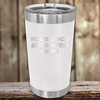 The Kodiak Coolers white stainless steel tumbler features a laser-engraved "Your Logo Engraved Here" design, displayed on a wooden surface. Perfect for custom tumblers at wholesale pricing during the Special Presidents Day Sale with no setup fee and a $250 minimum order.
