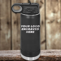A sleek black Kodiak Coolers insulated bottle with an engraved logo sits on a wooden surface against a blurred wood backdrop, perfect for custom tumblers. Enjoy wholesale pricing during our Presidents Day Sale with no setup fee and a $250 minimum order.
