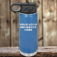 A Kodiak Coolers blue insulated water bottle with a black lid features a laser-engraved "Your Logo Engraved Here" text, set against a blurred wooden background.