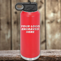 A red Kodiak Coolers Custom Water Bottle 40 oz with a black lid rests on wood, featuring "YOUR LOGO ENGRAVED HERE" in white. Limited time Black Friday sale—add your logo or design with special volume pricing!.