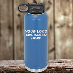 A Kodiak Coolers custom engraved blue water bottle with a black lid sits on wood, featuring "YOUR LOGO ENGRAVED HERE." This showcases the option for personalized logos on our drinkware, with no setup fee and one side logo included in the Presidents Day sale. $250 minimum order applies.