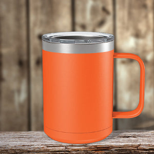 An orange Custom Coffee Mug 15 oz with your Logo or Design Engraved from Kodiak Coolers, sitting on a wooden table.