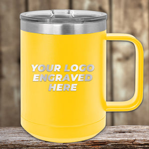 A yellow Kodiak Coolers 15 oz insulated mug with a silver lid sits on wood, showcasing the laser-engraved text "Your Logo Engraved Here," making it a perfect custom coffee mug for your collection.