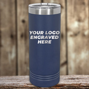 A navy blue insulated Kodiak Coolers custom skinny tumbler with "your logo engraved here" text on a wooden surface.