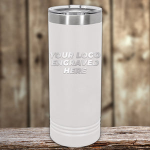 White insulated Custom Skinny Tumblers 22 oz with your Logo or Design Engraved displayed on a wooden surface with a blurred background by Kodiak Coolers.