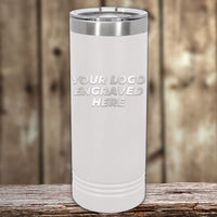 A white insulated Kodiak Coolers tumbler with "Your Logo Engraved Here" laser-engraved on it sits on a wooden surface with a blurred background. Perfect for custom tumblers, available at wholesale prices with no setup fee and $250 minimal order during Presidents Day Sale.
