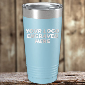 Blue insulated tumbler from Kodiak Coolers, perfect as a corporate promotional gift, with customizable engraving option displayed on a wooden surface.