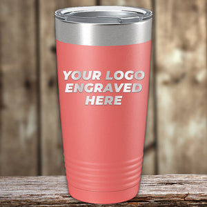 Promotional coral-colored Kodiak Coolers custom tumblers engraved, displayed on a wooden surface.