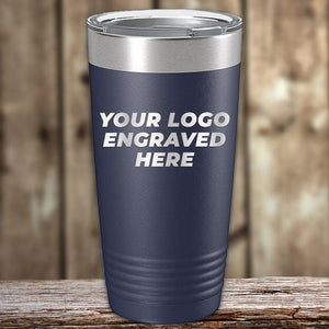 A dark blue Kodiak Coolers tumbler with a silver lid and an engraved logo option sits on a wooden surface. This custom drinkware is perfect for personalization, offering 1 side logo engraving with no setup fee during the $250 minimal order Presidents Day sale.