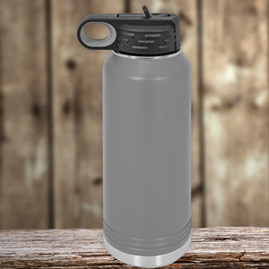 Gray insulated stainless steel Custom Water Bottles 32 oz with your Logo or Design Engraved - Special New Years Sale Bulk Pricing - LIMITED TIME, with a flip-top lid, resting on a wooden surface against a blurred wooden backdrop by Kodiak Coolers.