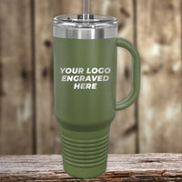 Showcase your logo on a green travel mug with a handle and straw from Kodiak Coolers. This custom engraved drinkware, set against a blurred wood background, is perfect for those seeking wholesale pricing. Minimal order $250 during the Presidents Day Sale; no setup fee and 1 side logo included.