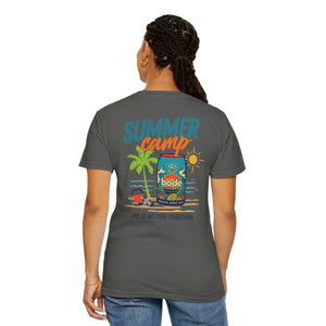 A person faces away, wearing the Printify BODE Summer Camp T-Shirt 2026—a unisex, garment-dyed gray Comfort Colors 1717 tee with a vibrant "Life's Better Together" summer camp graphic featuring palm trees, sun, and water on the back.