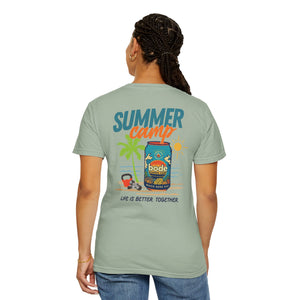 A person faces away wearing the BODE Summer Camp T-Shirt 2026 by Printify, a light green unisex Comfort Colors 1717 tee featuring a vibrant "Summer camp" graphic and “Life’s Better Together” text on the back with durable double-needle stitching.