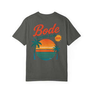 The BODE Summer Camp T-Shirt 2026 — "Throwback Sunset" by Printify features a dark gray Comfort Colors 1717 unisex cotton tee with bold "Bode Summer Camp 2026," a sunset graphic, and two palm trees on the back.