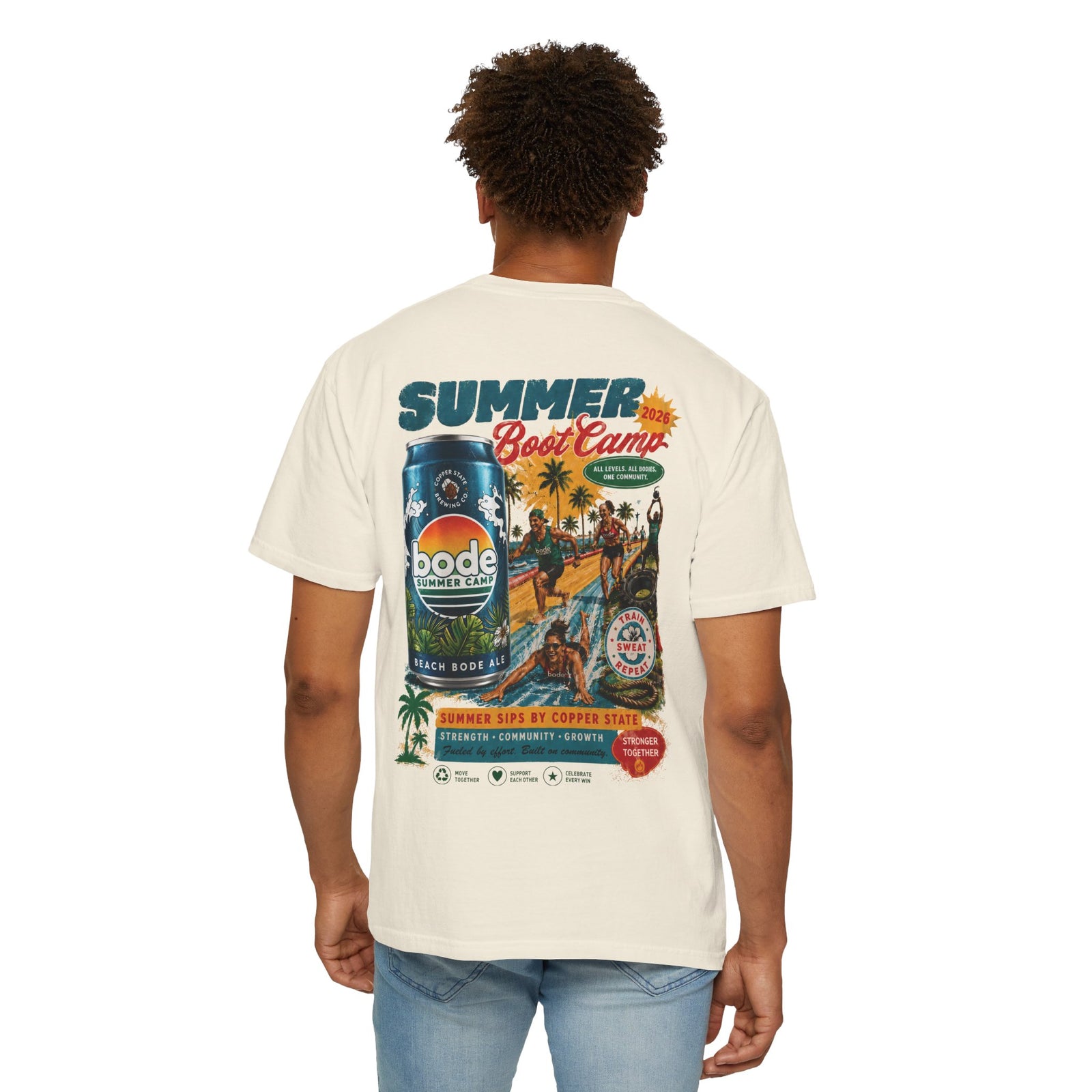 A person wearing a Printify BODE Summer Camp T-Shirt 2026—Vintage Design (Unisex Comfort Colors 1717) with a colorful "Summer Boot Camp" and can graphic on the back, made of soft heavyweight cotton, stands facing away from the camera.