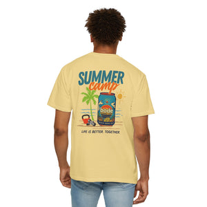 A person wearing the Printify BODE Summer Camp T-Shirt 2026 — "Life's Better Together", a yellow heavyweight cotton unisex tee featuring palm trees, a drink can, and the “LIFE IS BETTER TOGETHER” graphic on the back.