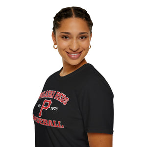 A woman with braided hair smiles at the camera, wearing a Printify P Reds Baseball Est. 1978 - Unisex Softstyle T-Shirt featuring bold red and white lettering.