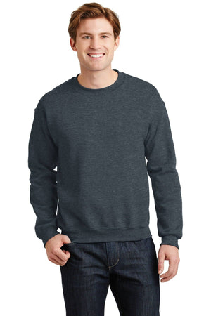 A person wearing a dark grey Gildan Heavy Blend Crewneck Sweatshirt 18000 and jeans is standing and smiling.