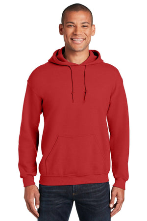 A person wearing a Gildan Heavy Blend Hoodie Sweatshirt 18500 in plain red, featuring a front pocket and drawstrings, stands and smiles against a white background.