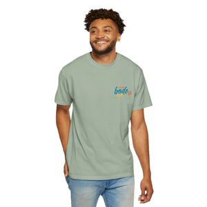 A person wears the Printify BODE Summer Camp T-Shirt 2026—"Life's Better Together," a light green Comfort Colors 1717 tee with a small colorful left-chest graphic, standing and smiling against a plain background.