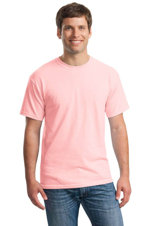 A man smiles, wearing a Gildan Heavy 100% Cotton Custom T-Shirt (Gildan 5000) in light pink and blue jeans, standing against a white background.
