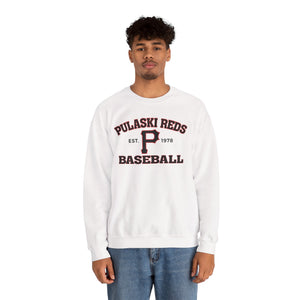 A person wears the Printify P Reds Baseball Est. 1978 - Unisex Heavy Blend™ Crewneck Sweatshirt with "Pulaski Reds Baseball Est. 1978" on the front, styled with blue jeans and standing against a white background.