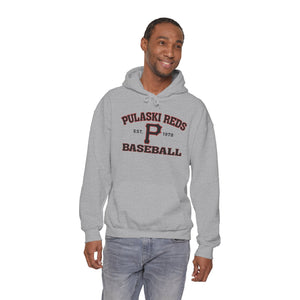 A man stands and smiles against a white background wearing the Printify P Reds Baseball Est. 1978 Unisex Heavy Blend™ Hooded Sweatshirt.