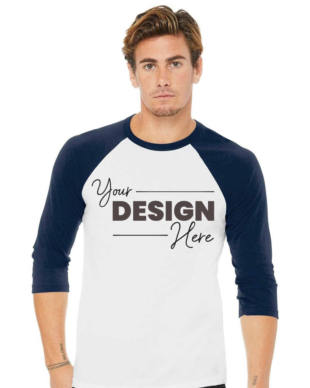 A person wearing a Bella Canvas Unisex 3/4-Sleeve Baseball T-Shirt BC3200 in white and black, made from Bella + Canvas's Airlume combed and ring-spun cotton, featuring the text "Your Design Here.
