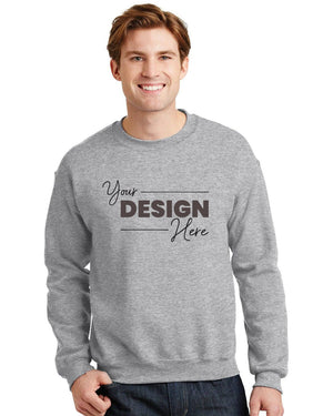 A person wearing a Gildan Heavy Blend Crewneck Sweatshirt 18000 in gray, featuring "Your Design Here" on the front, crafted from a comfortable and durable 50/50 cotton polyester blend.