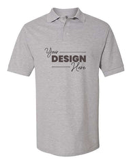 The Jerzees 100% Ringspun Cotton Pique Polo by JERZEES is a gray short-sleeve shirt with a collar and three buttons. It features the text 