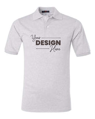 A light grey JERZEES Jerzees Midweight Polo Cotton Poly Blend SpotShield 50/50 with short sleeves and a collar. The shirt features the phrase 