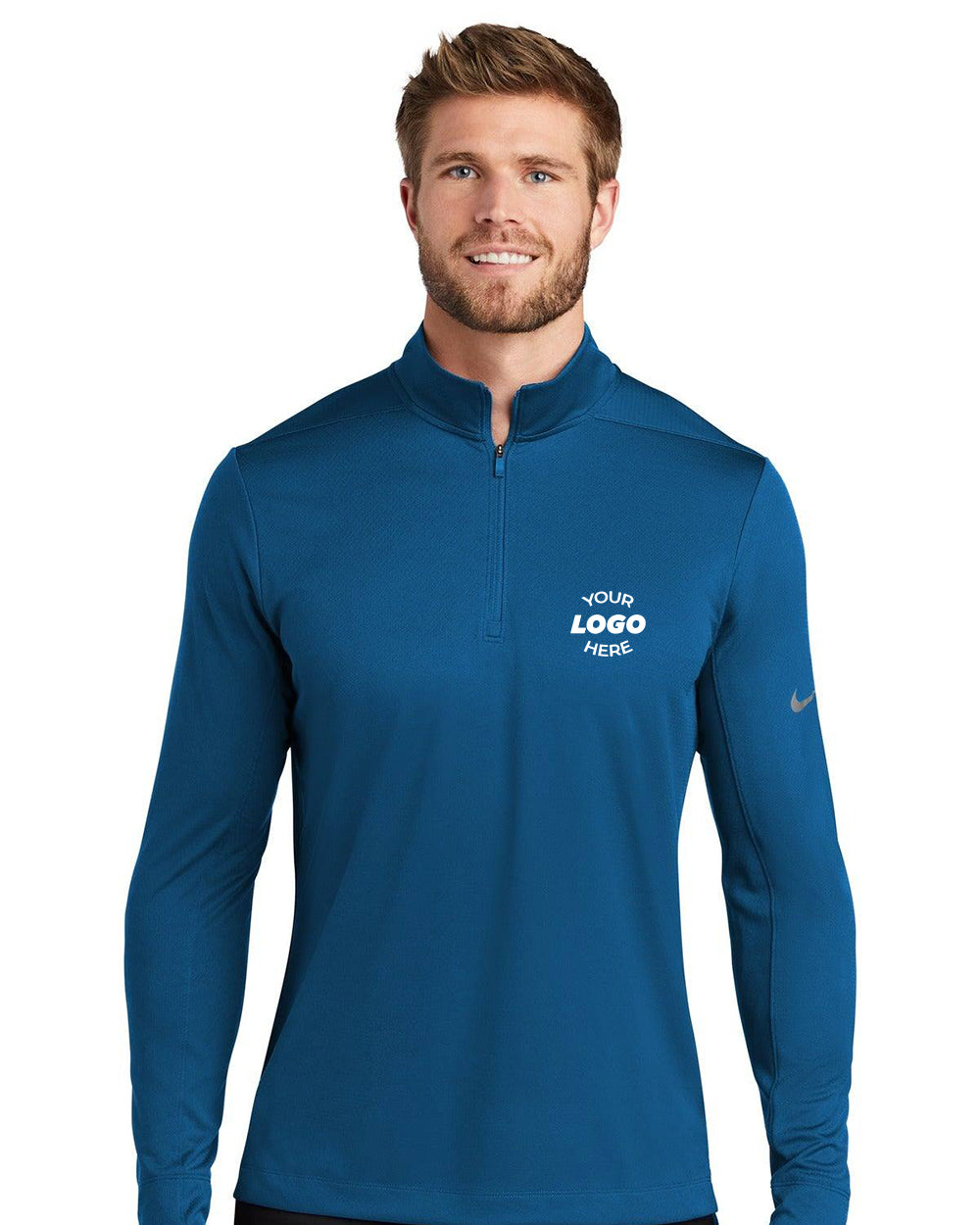 A man wearing a Nike Dry 1/2-Zip Cover-Up Pullover (NKBV6044) with "Your Logo Here" embroidered on the left chest and a small Nike logo on the sleeve, made with Dri-FIT technology for exceptional comfort.