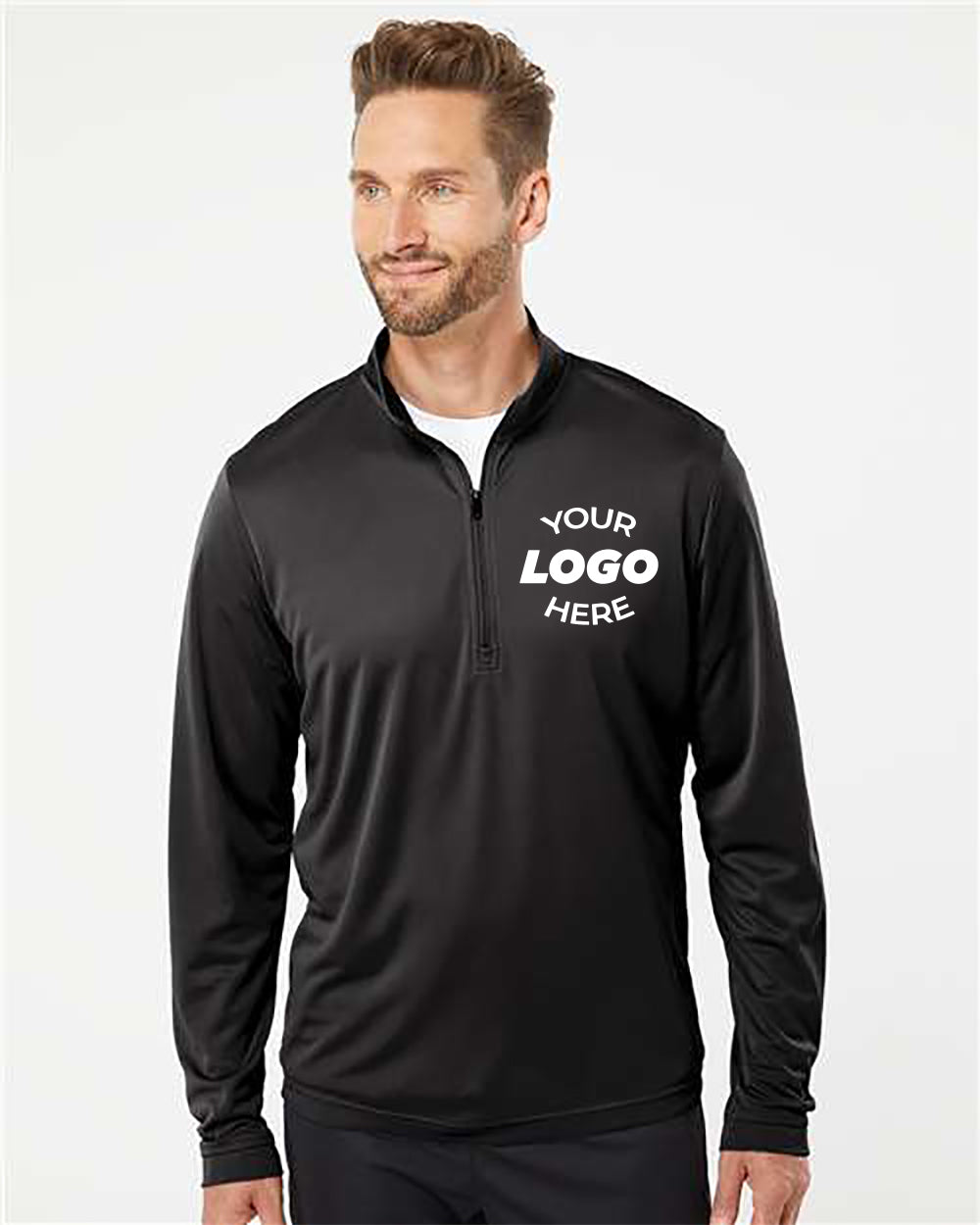 A man with short hair and a beard is wearing an Adidas Lightweight Quarter-Zip Pullover, which is made entirely of recycled polyester and provides UPF 50+ protection. The black pullover features placeholder text "YOUR LOGO HERE" on the left chest area.