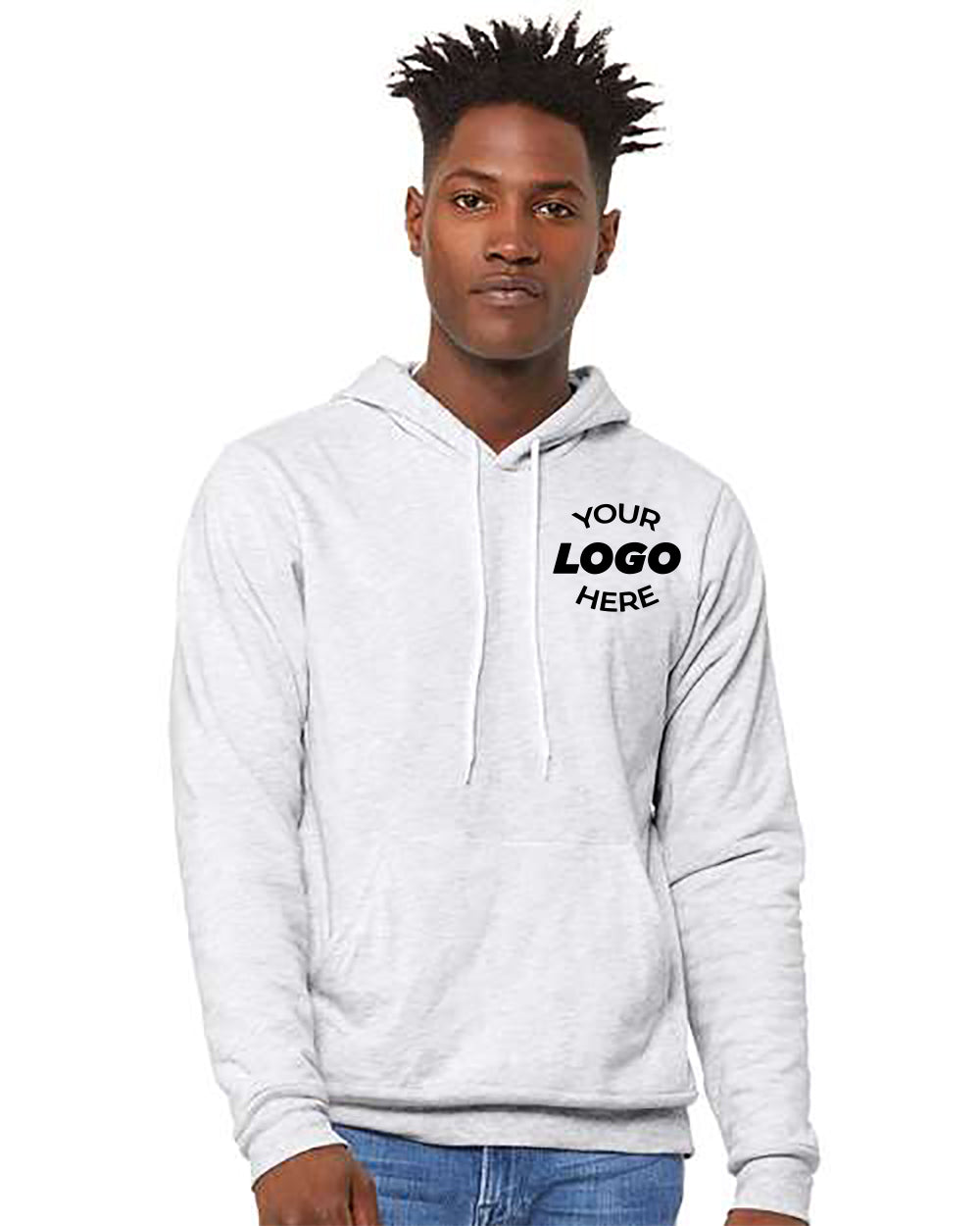 A person wearing a light grey, Bella Canvas Unisex Sponge Fleece Hoodie Sweatshirt by BELLA + CANVAS with "YOUR LOGO HERE" text on the chest stands against a plain background.