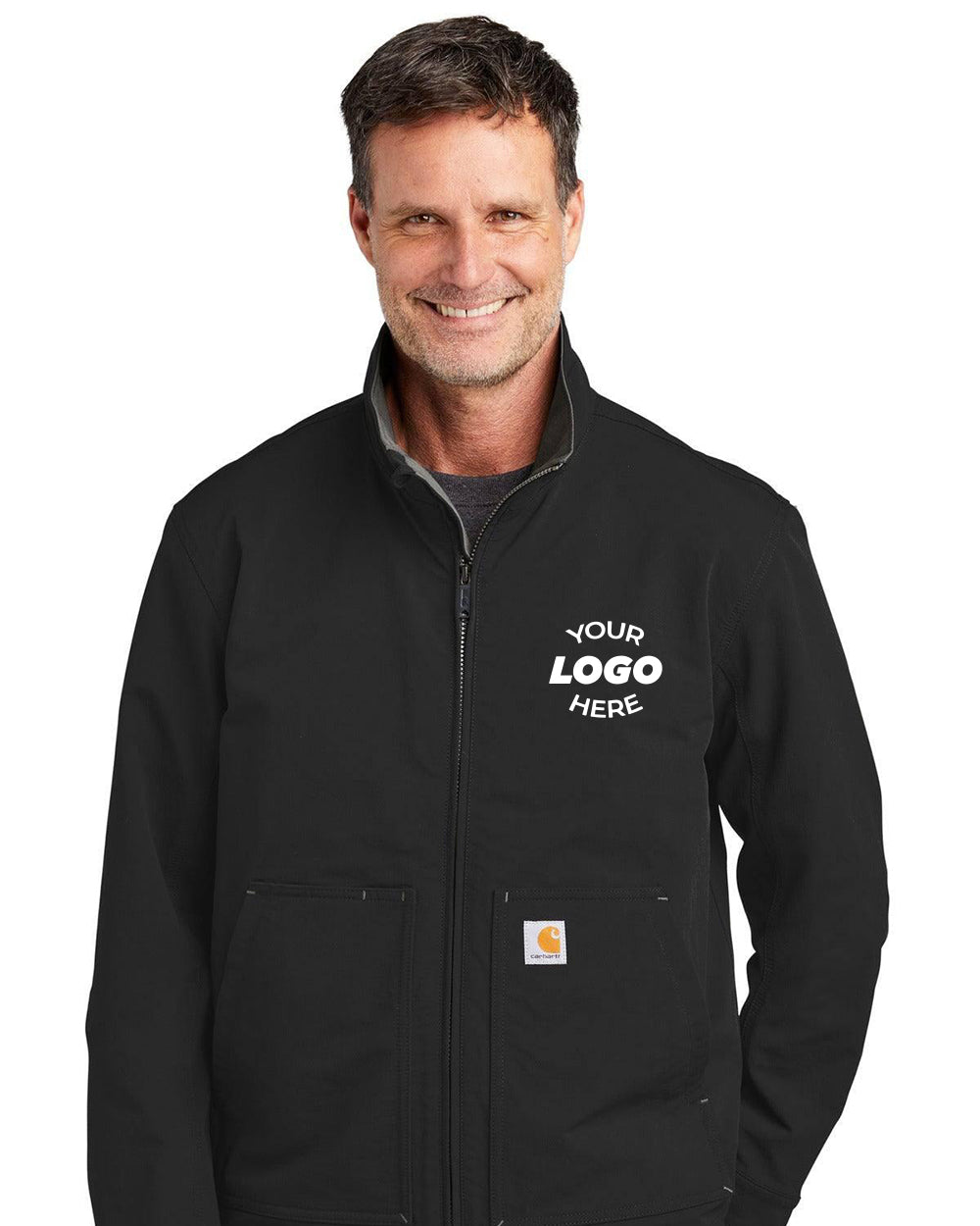 A man wearing a black Carhartt Super Dux Soft Shell Jacket CT105534 with "Your Logo Here" on the left chest stands and smiles.
