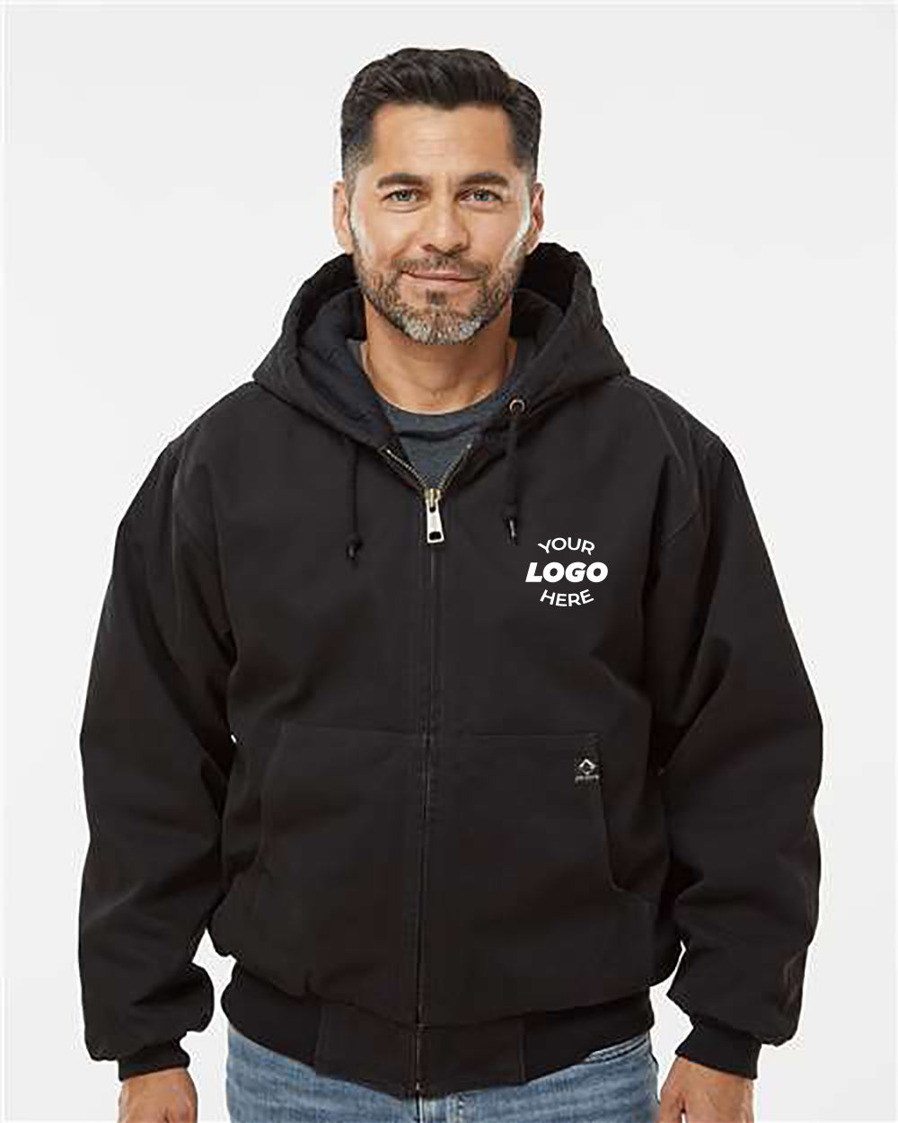 A man with short hair and a beard wears a black DRI DUCK Cheyenne Boulder Cloth Hooded Jacket with Tricot Quilt Lining, featuring "Your Logo Here" printed on it. He stands against a plain white background, showcasing the durable style of the jacket.