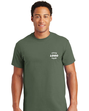 A man wearing a Gildan - 100% US Cotton T-Shirt 2000 in green, adorned with a "Your Logo Here" design on the chest.